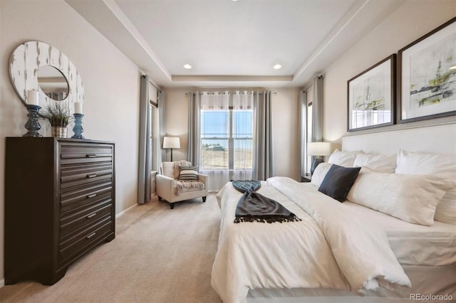 bedroom featuring light colored carpet, recessed lighting, and a raised ceiling