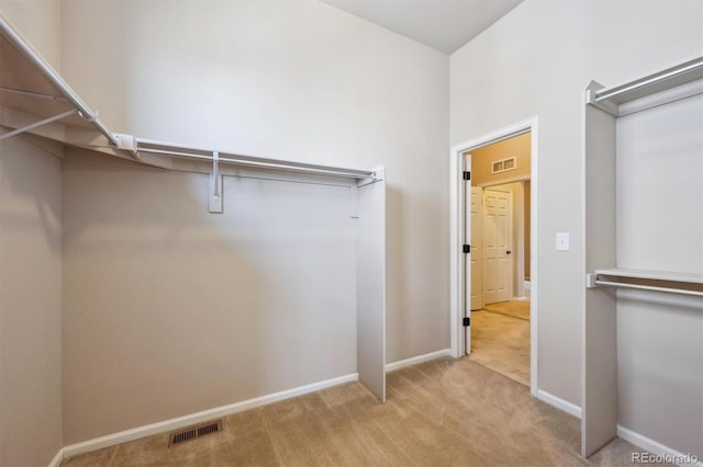 walk in closet featuring visible vents and carpet flooring