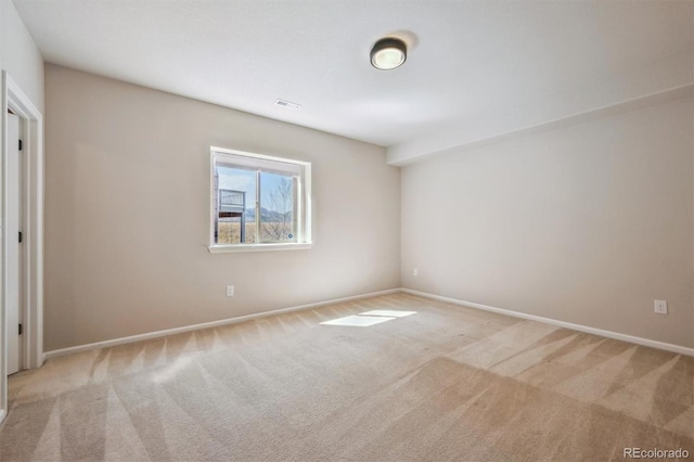 carpeted empty room with baseboards and visible vents