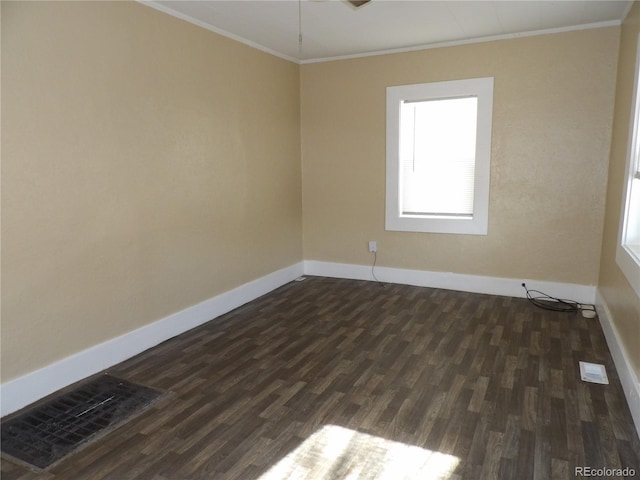 unfurnished room featuring baseboards, dark wood-type flooring, visible vents, and crown molding