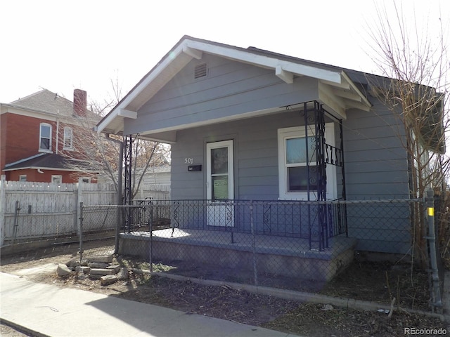 view of front of home with covered porch and fence