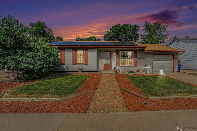 9354 Field Ln, Broomfield, CO 80021 - ranch-style home with an attached garage, driveway, solar panels, and a yard