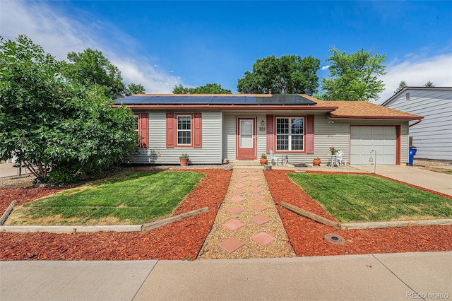 9354 Field Ln, Broomfield, CO 80021 - ranch-style house with an attached garage, a front lawn, solar panels, and driveway