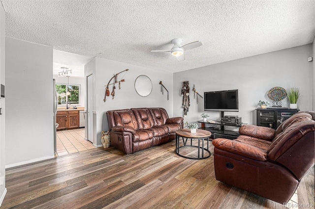 9354 Field Ln, Broomfield, CO 80021 - living area featuring wood finished floors, a textured ceiling, and a ceiling fan