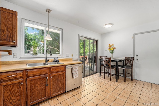 9354 Field Ln, Broomfield, CO 80021 - kitchen with stainless steel dishwasher, light tile patterned flooring, light countertops, and plenty of natural light