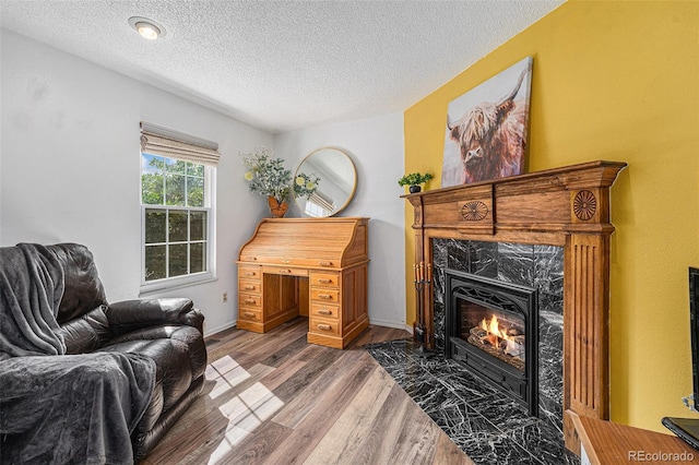 9354 Field Ln, Broomfield, CO 80021 - sitting room featuring a textured ceiling, wood finished floors, and a fireplace