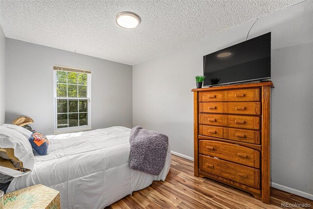 9354 Field Ln, Broomfield, CO 80021 - bedroom featuring wood finished floors and a textured ceiling