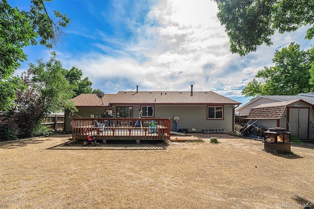 9354 Field Ln, Broomfield, CO 80021 - back of property with a storage unit, a wooden deck, and an outdoor fire pit