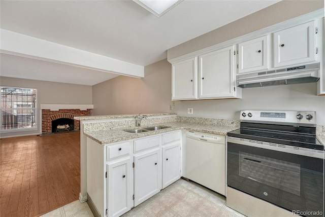 kitchen with under cabinet range hood, dishwasher, a peninsula, electric range, and a sink