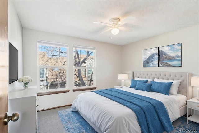 bedroom featuring baseboards, a ceiling fan, and carpet flooring