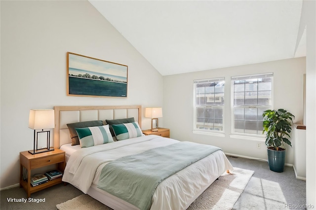 carpeted bedroom with baseboards and lofted ceiling