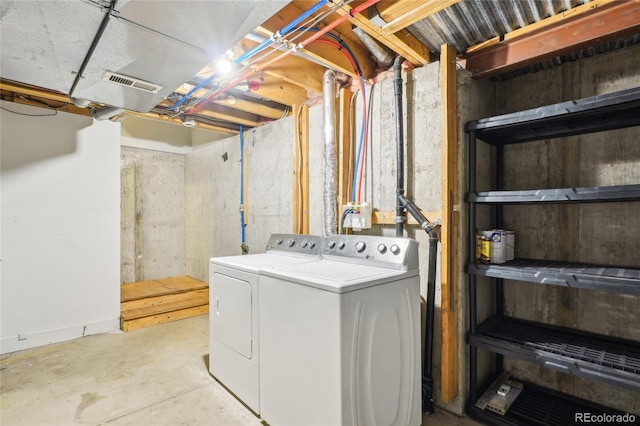 laundry room with visible vents, washing machine and dryer, and laundry area