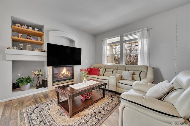 living room with hardwood / wood-style flooring and a fireplace