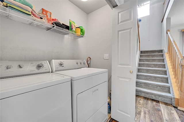 laundry area featuring hardwood / wood-style flooring and washing machine and dryer