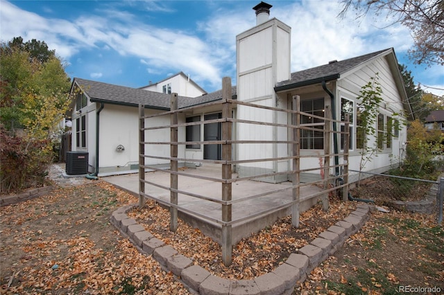 view of side of home featuring cooling unit and a patio