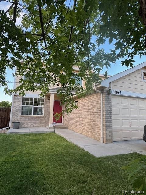 18897 E Linvale Pl, Aurora, CO 80013 - view of front of home with brick siding and a garage