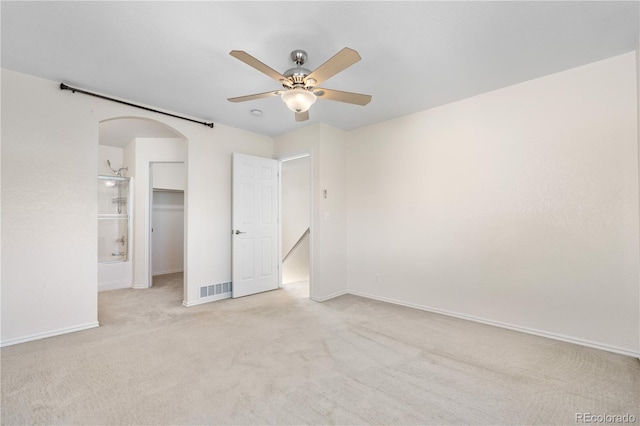18897 E Linvale Pl, Aurora, CO 80013 - unfurnished bedroom with light colored carpet, baseboards, arched walkways, a ceiling fan, and a spacious closet