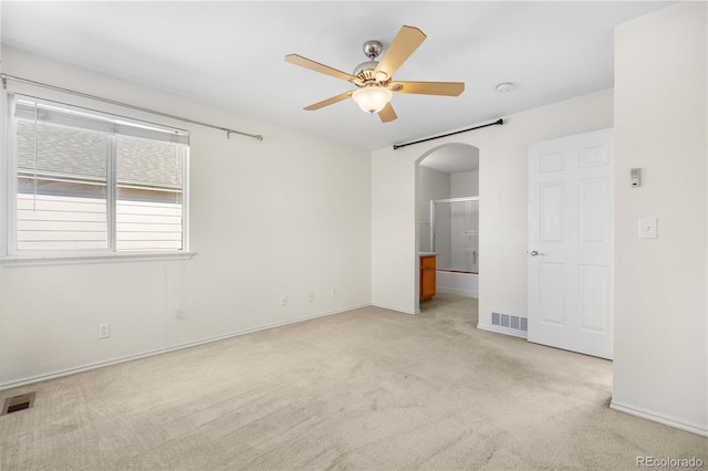 18897 E Linvale Pl, Aurora, CO 80013 - unfurnished bedroom with light colored carpet, arched walkways, baseboards, and ensuite bathroom