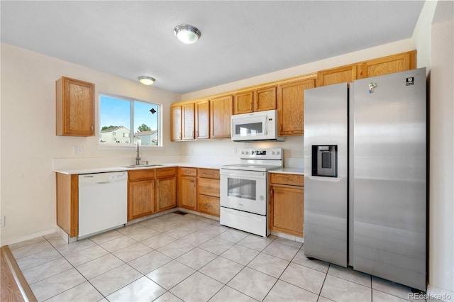 18897 E Linvale Pl, Aurora, CO 80013 - kitchen with white appliances, a sink, light countertops, and light tile patterned floors