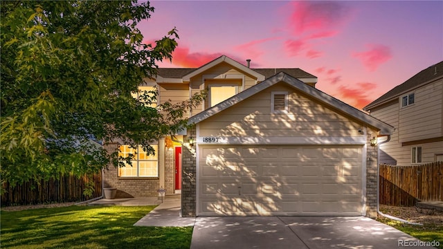 18897 E Linvale Pl, Aurora, CO 80013 - view of front of home featuring brick siding, an attached garage, and concrete driveway