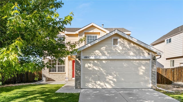 18897 E Linvale Pl, Aurora, CO 80013 - traditional-style house featuring brick siding, an attached garage, and driveway