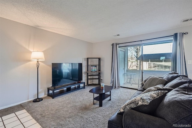 living area with carpet, baseboards, a textured ceiling, and visible vents