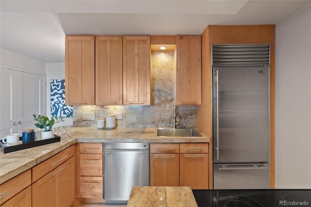 kitchen featuring a sink, tasteful backsplash, built in fridge, and tile countertops