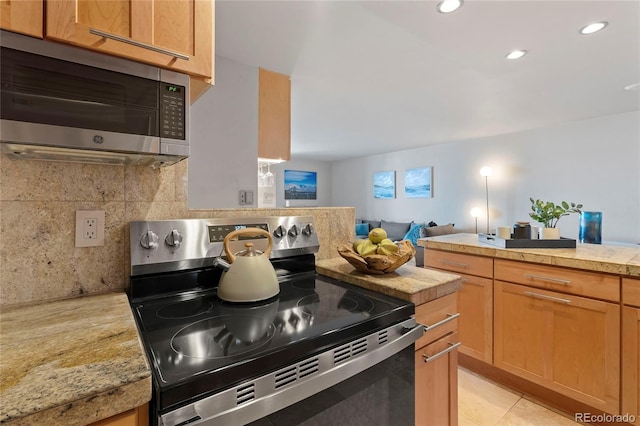 kitchen with tasteful backsplash, open floor plan, light tile patterned floors, recessed lighting, and stainless steel appliances