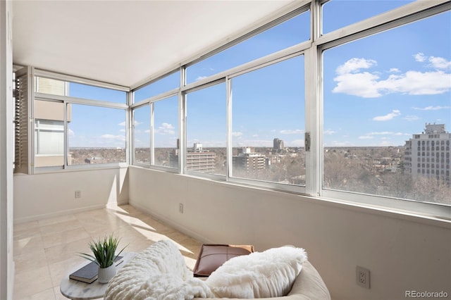 sunroom with a wealth of natural light and a city view