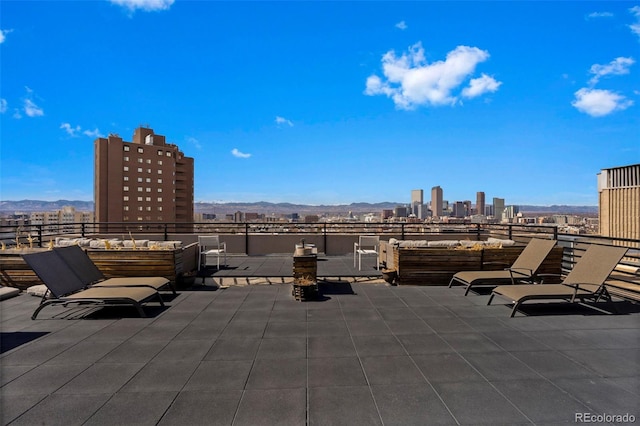 view of patio / terrace featuring a city view and a mountain view