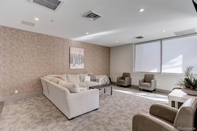 living area with visible vents, recessed lighting, and wallpapered walls