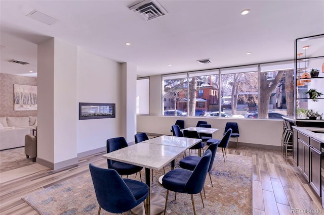 dining area with recessed lighting, light wood-style floors, visible vents, and baseboards