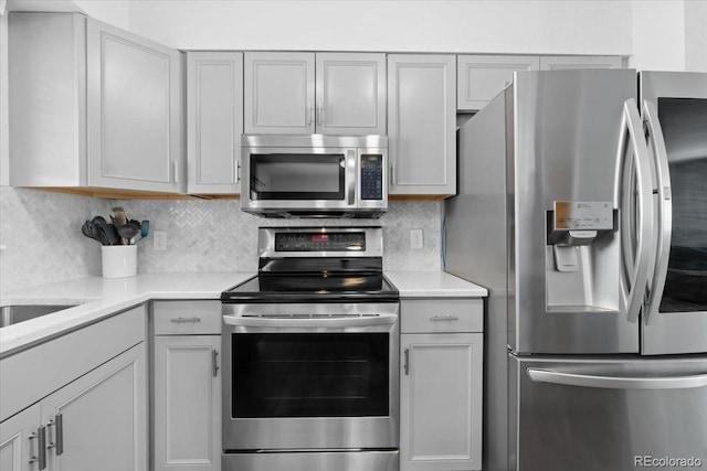 kitchen featuring stainless steel appliances and backsplash