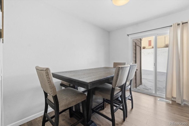 dining space featuring wood-type flooring