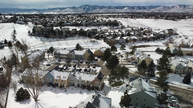 snowy aerial view featuring a mountain view