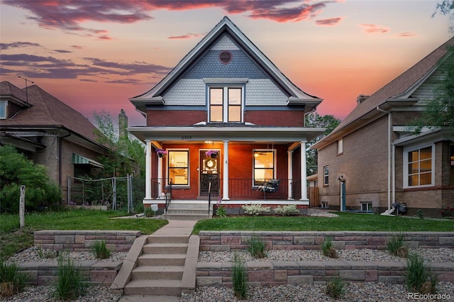 3008 N York St, Denver, CO 80205 - victorian home with a porch, brick siding, and a yard