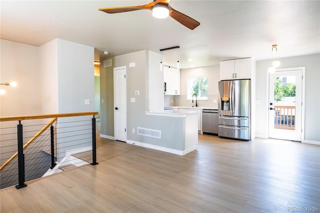 10932 W 107th Ave, Broomfield, CO 80021 - kitchen with stainless steel appliances, light wood-style flooring, light countertops, and a ceiling fan