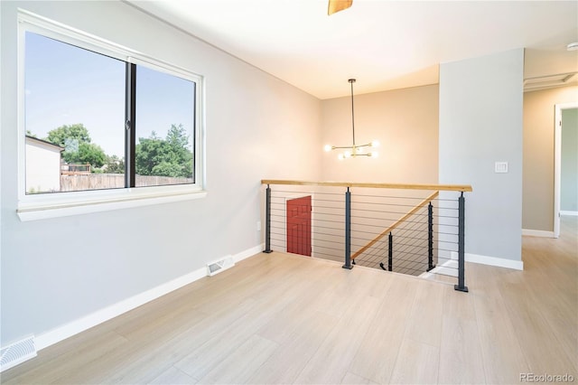 10932 W 107th Ave, Broomfield, CO 80021 - unfurnished room with wood finished floors and a chandelier