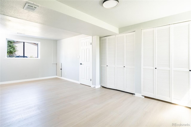 10932 W 107th Ave, Broomfield, CO 80021 - unfurnished bedroom with two closets and light wood-type flooring