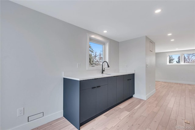 kitchen featuring sink and light wood-type flooring