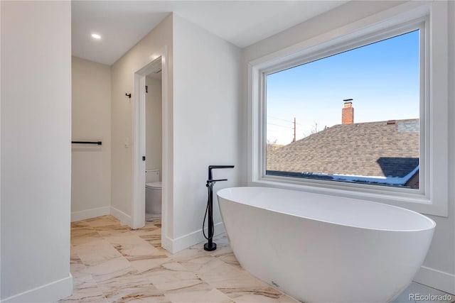 bathroom with toilet and a bathtub