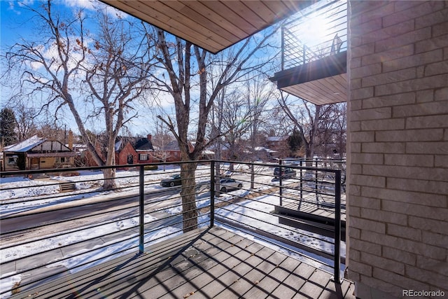 view of snow covered back of property