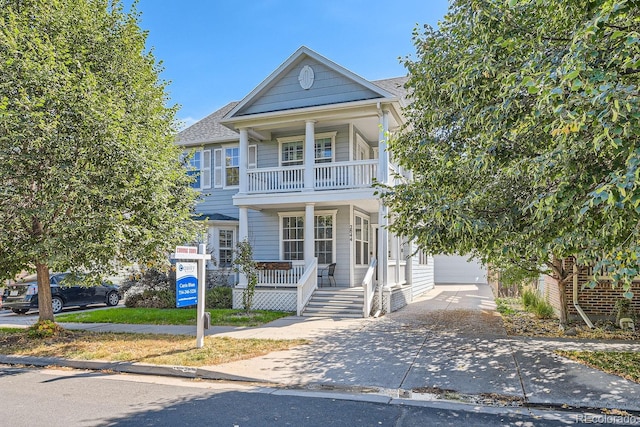 view of front of home with a garage, covered porch, and a balcony