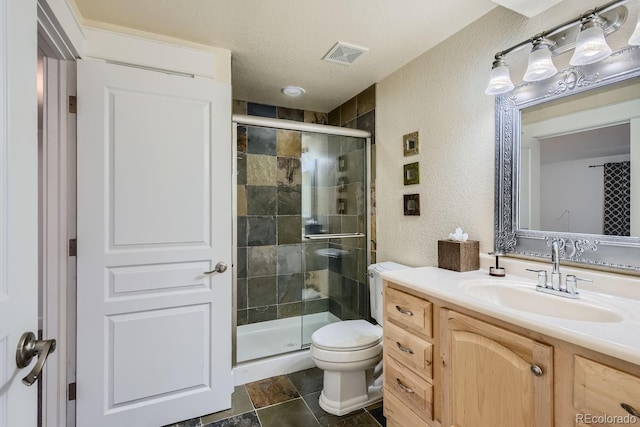 bathroom with walk in shower, vanity, a textured ceiling, and toilet