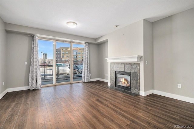 9039 E Panorama Cir Unit C201, Englewood, CO 80112 - unfurnished living room with wood finished floors, a fireplace, and a city view
