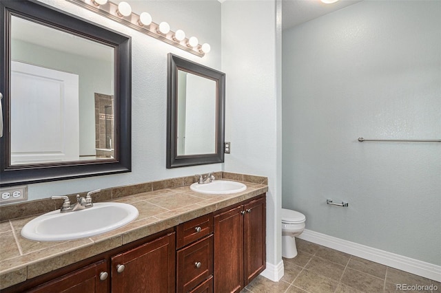9039 E Panorama Cir Unit C201, Englewood, CO 80112 - bathroom featuring double vanity, tile patterned flooring, and a shower