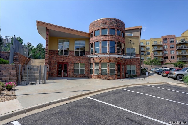 9039 E Panorama Cir Unit C201, Englewood, CO 80112 - view of building exterior featuring uncovered parking