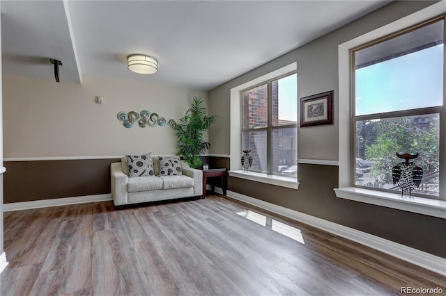 9039 E Panorama Cir Unit C201, Englewood, CO 80112 - living area featuring healthy amount of natural light and wood finished floors