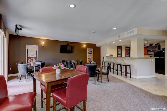9039 E Panorama Cir Unit C201, Englewood, CO 80112 - dining area featuring light carpet, recessed lighting, and light tile patterned floors