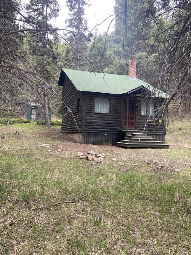 10504 Jackson Creek Rd, Sedalia, CO 80135 - view of front of house with a chimney